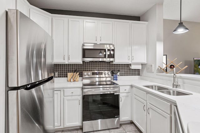 kitchen featuring light countertops, stainless steel appliances, white cabinetry, and a sink