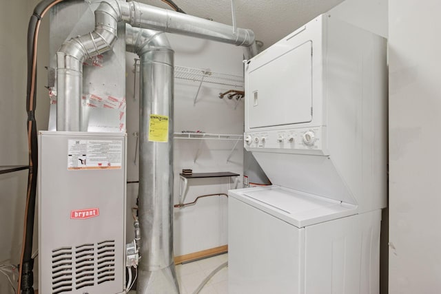 laundry room featuring laundry area, stacked washing maching and dryer, and heating unit