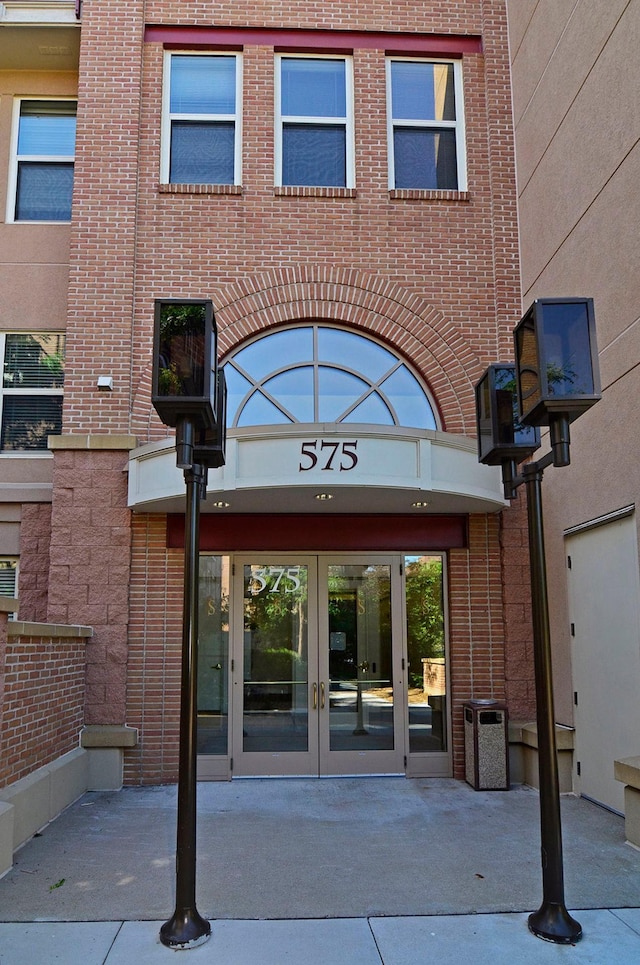 doorway to property with french doors and brick siding