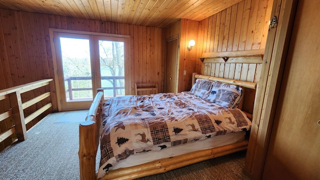 carpeted bedroom featuring wood ceiling and wooden walls