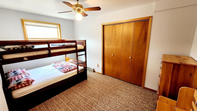 carpeted bedroom featuring a closet, ceiling fan, and a baseboard heating unit