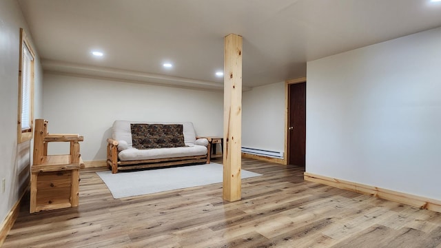 living area with baseboards, baseboard heating, recessed lighting, and wood finished floors