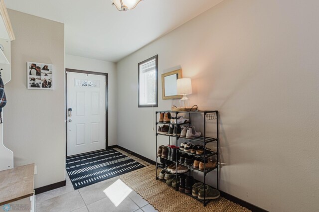 foyer with light tile patterned floors and baseboards