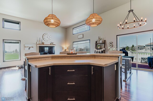 kitchen with open floor plan, dark wood finished floors, a chandelier, and light countertops