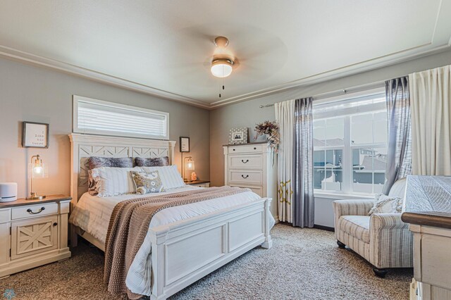 bedroom with a ceiling fan, multiple windows, and light carpet