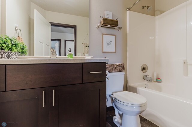 bathroom with shower / bath combination, vanity, and toilet