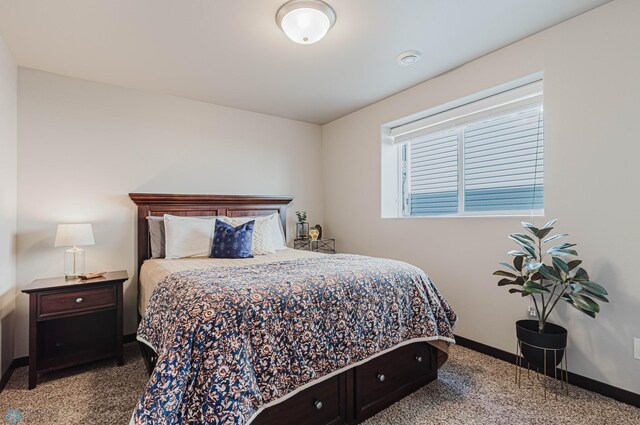 bedroom with baseboards and carpet flooring