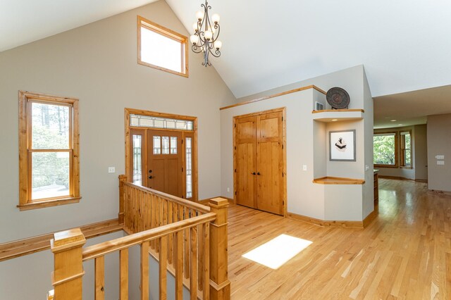 1315 Wicklow Ln SW, Rochester, MN 55902 - foyer entrance with light wood finished floors, high vaulted ceiling, a chandelier, and baseboards