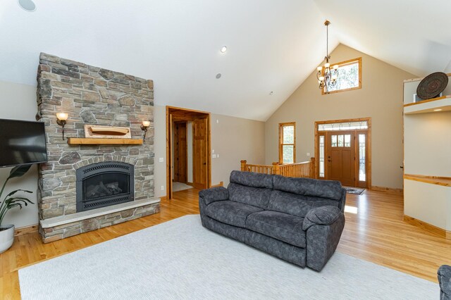 1315 Wicklow Ln SW, Rochester, MN 55902 - living room with wood finished floors, a stone fireplace, high vaulted ceiling, and baseboards