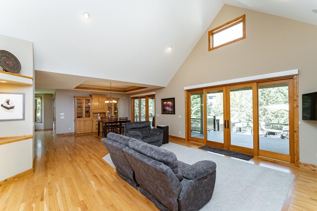 1315 Wicklow Ln SW, Rochester, MN 55902 - living room with a chandelier, baseboards, light wood-style flooring, high vaulted ceiling, and french doors