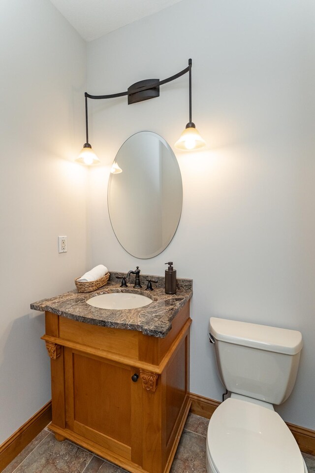1315 Wicklow Ln SW, Rochester, MN 55902 - bathroom with baseboards, toilet, and vanity