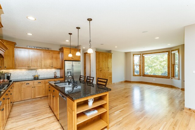 1315 Wicklow Ln SW, Rochester, MN 55902 - kitchen featuring appliances with stainless steel finishes, a sink, open shelves, light wood-style floors, and tasteful backsplash