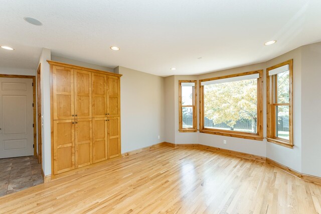 1315 Wicklow Ln SW, Rochester, MN 55902 - unfurnished bedroom with baseboards, recessed lighting, a closet, and light wood-type flooring
