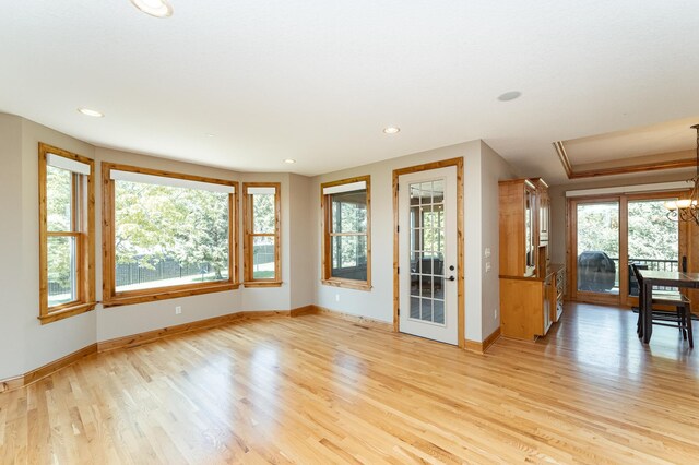 1315 Wicklow Ln SW, Rochester, MN 55902 - spare room featuring baseboards, light wood-style floors, healthy amount of natural light, recessed lighting, and a chandelier