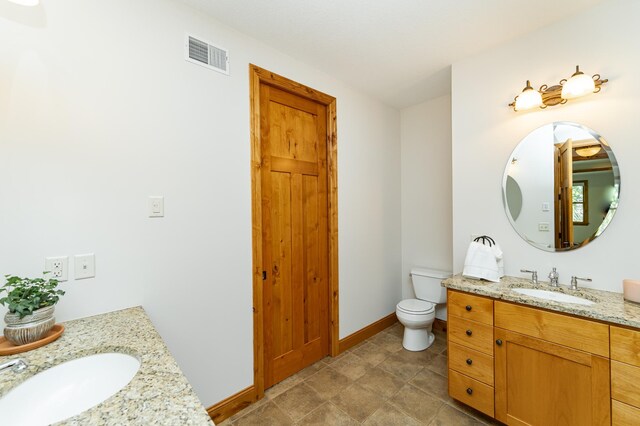 1315 Wicklow Ln SW, Rochester, MN 55902 - bathroom with two vanities, toilet, and baseboards