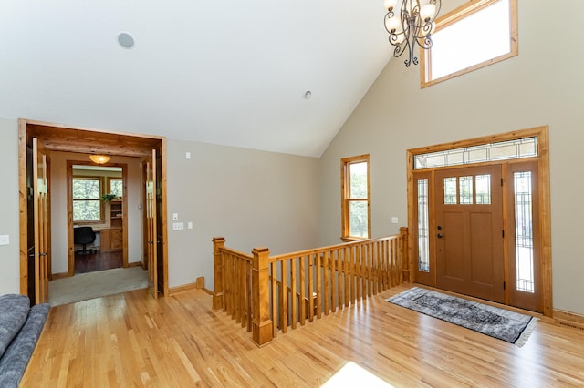 1315 Wicklow Ln SW, Rochester, MN 55902 - foyer entrance with light wood finished floors, high vaulted ceiling, a chandelier, and baseboards