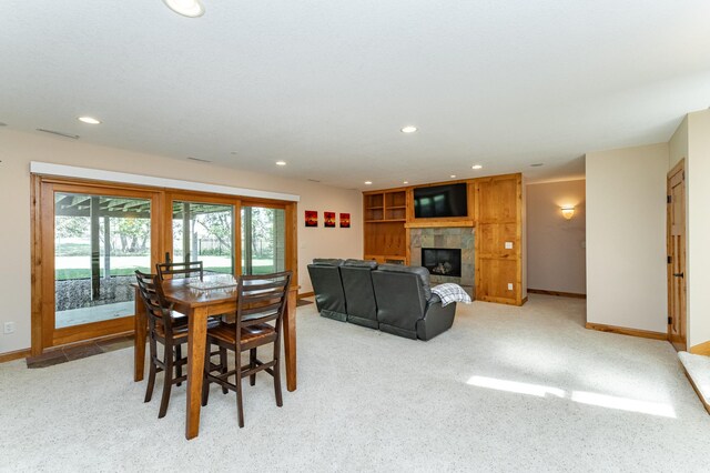 1315 Wicklow Ln SW, Rochester, MN 55902 - dining space featuring a tiled fireplace, light carpet, recessed lighting, and baseboards