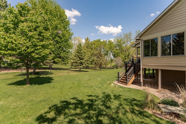 1315 Wicklow Ln SW, Rochester, MN 55902 - view of yard featuring stairway, a wooden deck, and view of wooded area