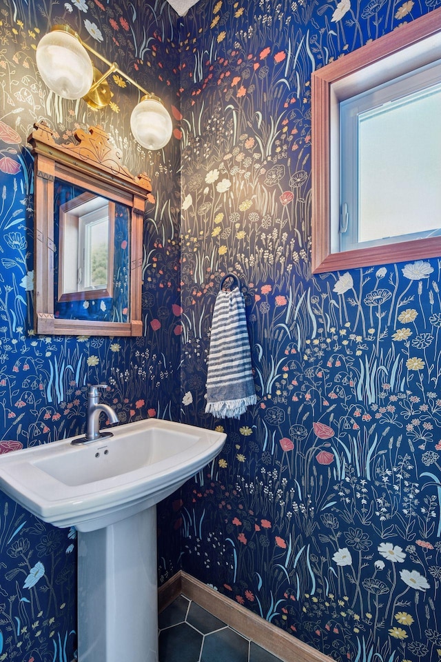 bathroom featuring wallpapered walls, baseboards, and tile patterned flooring