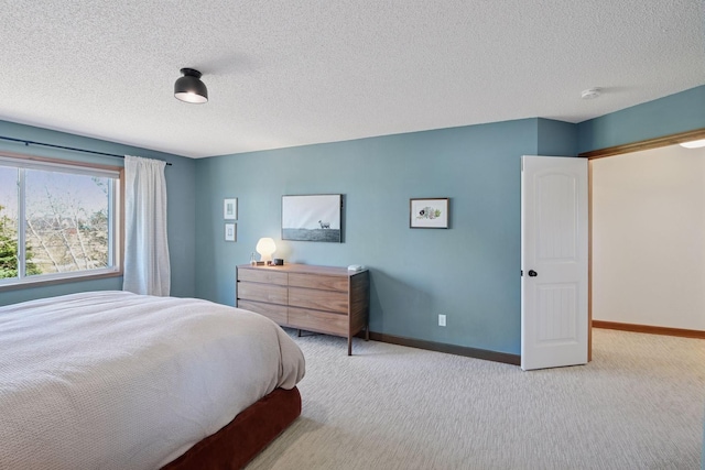 bedroom with baseboards, carpet flooring, and a textured ceiling