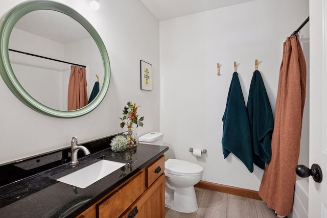 full bathroom featuring vanity, baseboards, toilet, and a shower with shower curtain