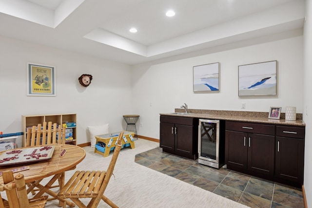 bar featuring wine cooler, baseboards, recessed lighting, a sink, and wet bar