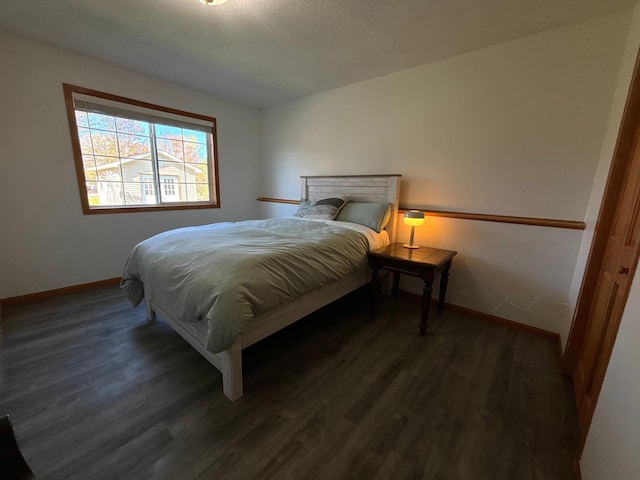 bedroom featuring baseboards and wood finished floors