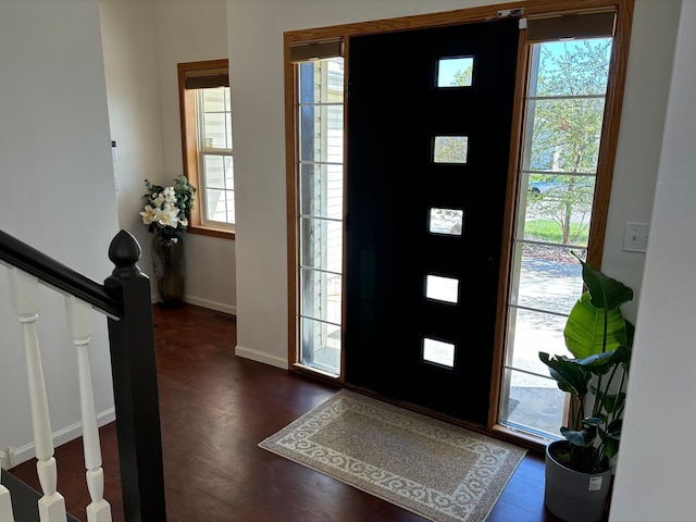 entryway with baseboards, stairs, and dark wood-style floors