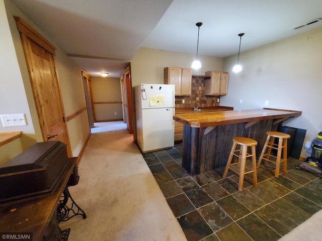 1603 86th Ave, Hammond Twp, WI 54015 - kitchen with freestanding refrigerator, wood counters, tasteful backsplash, a kitchen breakfast bar, and hanging light fixtures
