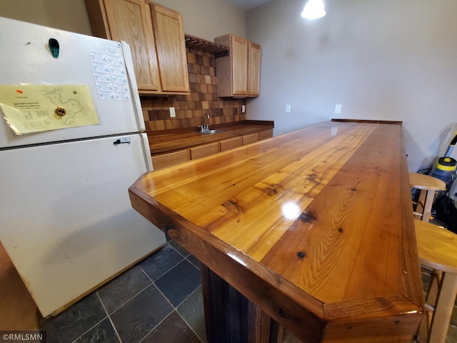 1603 86th Ave, Hammond Twp, WI 54015 - kitchen with freestanding refrigerator, wooden counters, decorative backsplash, a sink, and light brown cabinetry