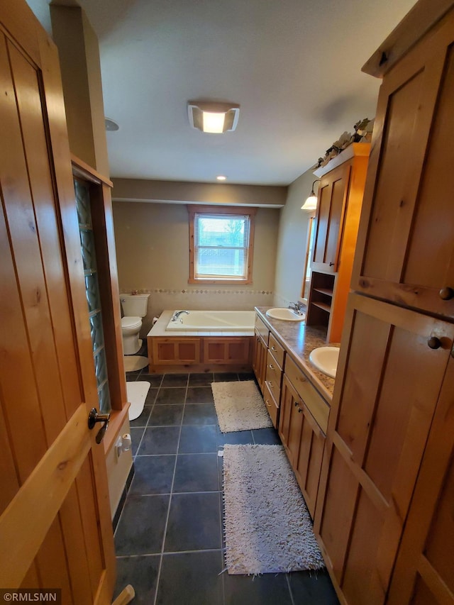 1603 86th Ave, Hammond Twp, WI 54015 - bathroom with tile patterned floors, a bath, toilet, and double vanity