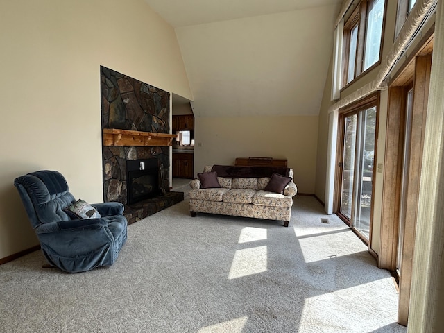 carpeted living room with high vaulted ceiling and a fireplace