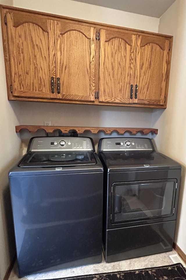laundry area with cabinet space and washing machine and clothes dryer