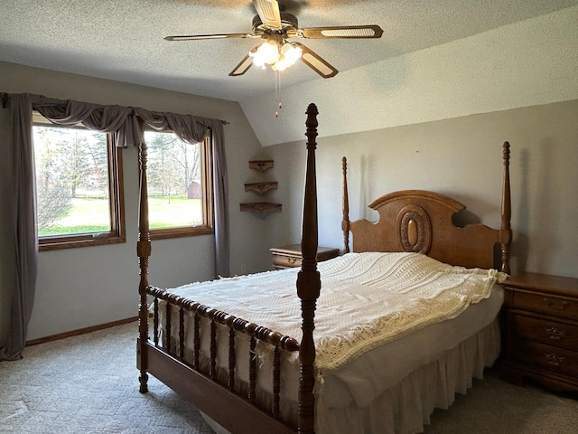 bedroom featuring light carpet, a textured ceiling, a ceiling fan, baseboards, and lofted ceiling