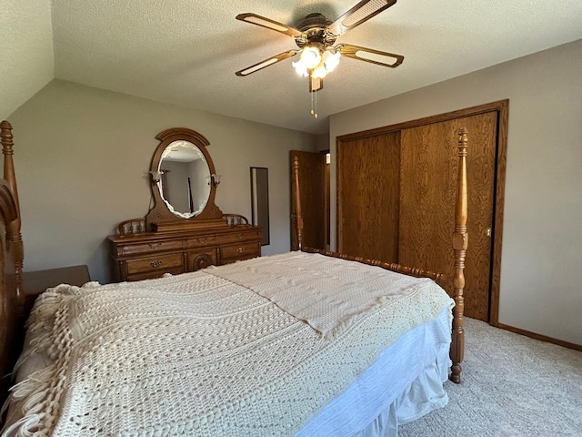 carpeted bedroom with ceiling fan, baseboards, lofted ceiling, and a closet