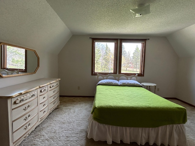 bedroom with light colored carpet, a textured ceiling, and lofted ceiling