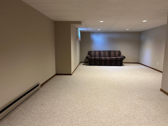 finished below grade area with light colored carpet, baseboards, a baseboard heating unit, and recessed lighting
