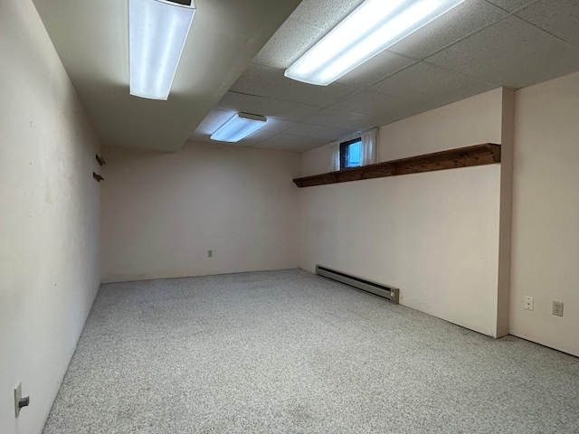 spare room featuring light colored carpet and baseboard heating