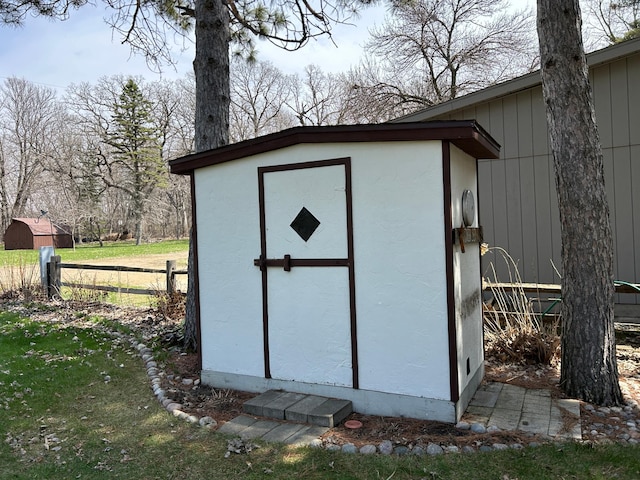 view of shed with fence