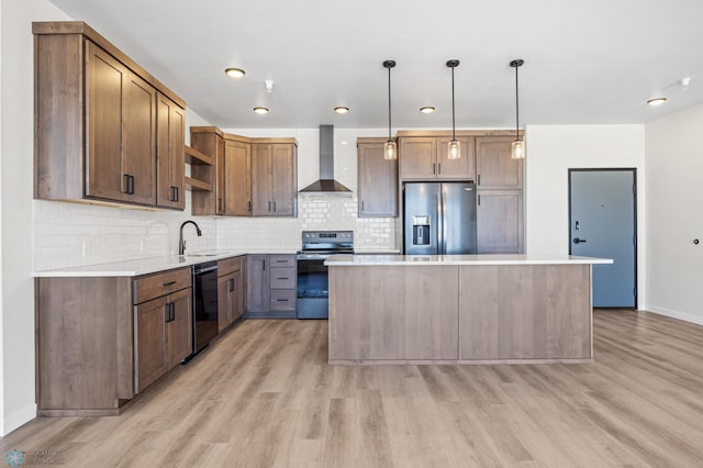 kitchen featuring open shelves, wall chimney exhaust hood, light wood finished floors, and stainless steel appliances
