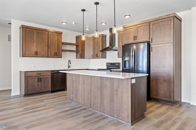 kitchen with a kitchen island, open shelves, wall chimney exhaust hood, stainless steel appliances, and light wood-style flooring