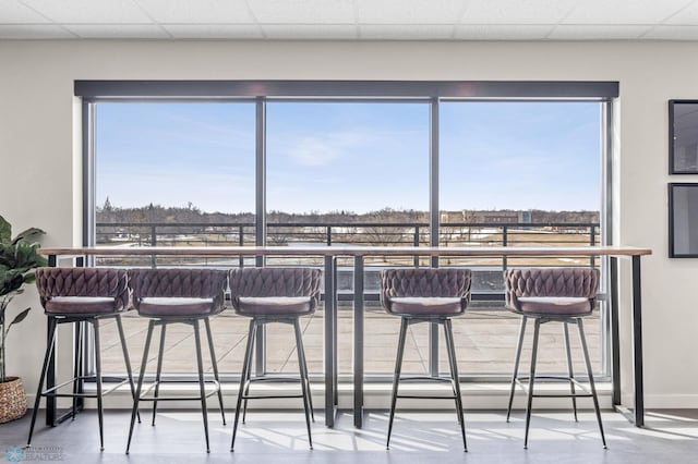dining space featuring a drop ceiling