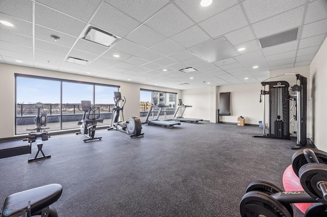 exercise room with a drop ceiling and visible vents