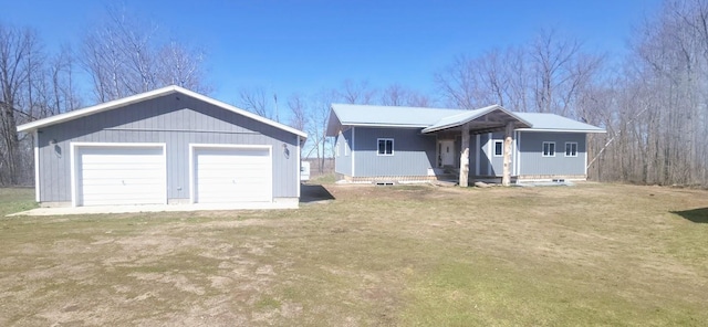 single story home featuring an outbuilding and a detached garage