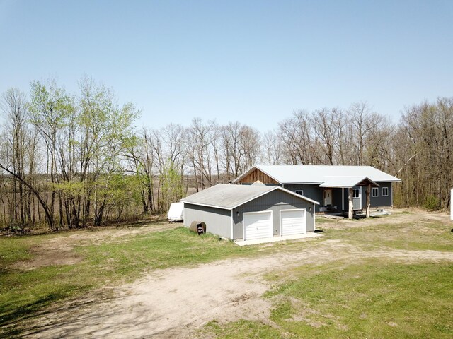 48751 153rd Ave, Verndale, MN 56481 - view of home's exterior with a garage, dirt driveway, and a lawn