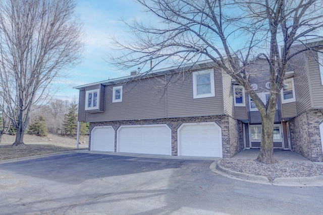 1870 Southpointe Ter Unit W1870, Eagan, MN 55122 - view of front of house featuring brick siding, driveway, and a garage