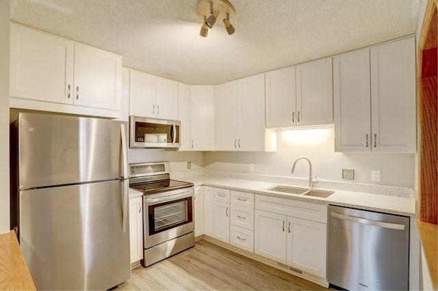 1870 Southpointe Ter Unit W1870, Eagan, MN 55122 - kitchen featuring a sink, light countertops, white cabinets, and stainless steel appliances