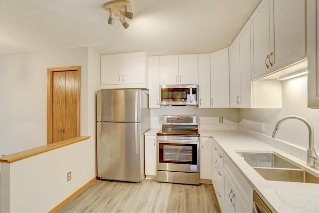 1870 Southpointe Ter Unit W1870, Eagan, MN 55122 - kitchen with light wood-style floors, a sink, white cabinetry, and appliances with stainless steel finishes