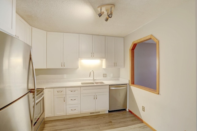 1870 Southpointe Ter Unit W1870, Eagan, MN 55122 - kitchen featuring light wood-style floors, a sink, white cabinetry, and stainless steel appliances