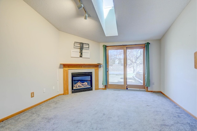 1870 Southpointe Ter Unit W1870, Eagan, MN 55122 - unfurnished living room with a skylight, carpet floors, baseboards, track lighting, and a glass covered fireplace